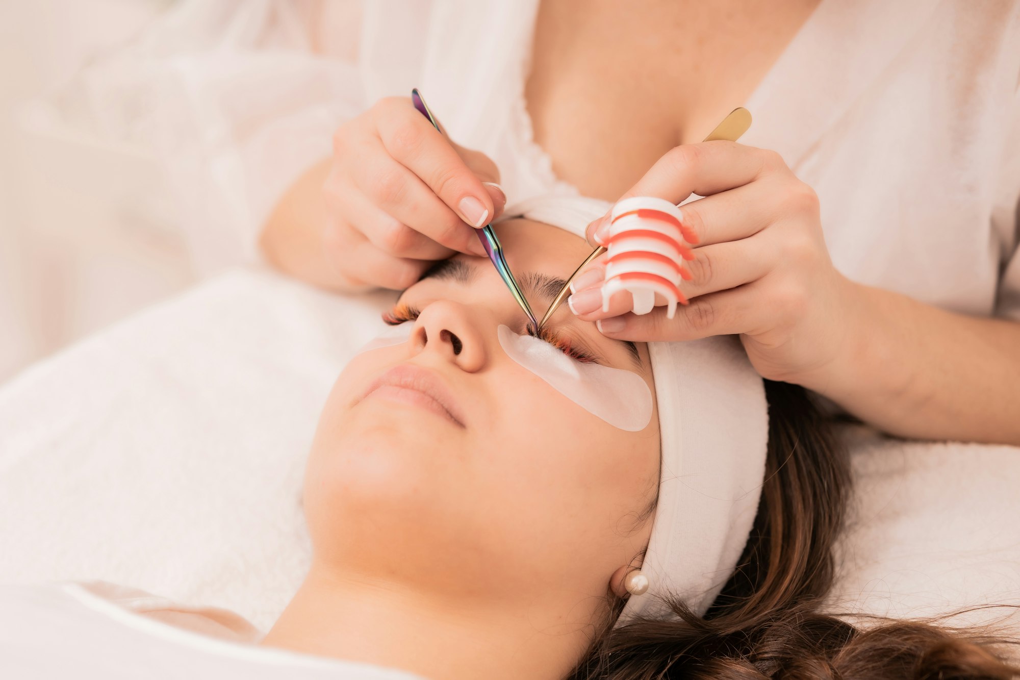 Skillful cosmetologist doing lash extension procedure - Beauty concept